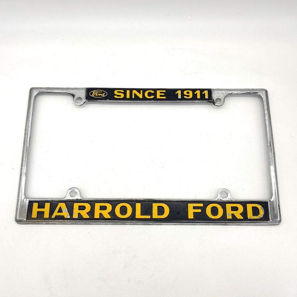 Vintage Harrold Ford Since 1911 License Plate Frame Chrome Metal Black Yellow